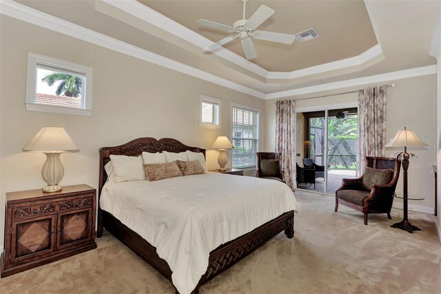 bedroom with a tray ceiling, multiple windows, access to outside, and ceiling fan