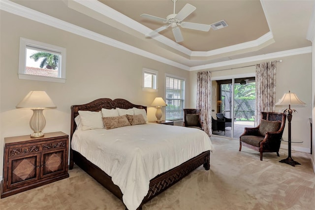 bedroom featuring carpet, visible vents, a tray ceiling, ornamental molding, and access to exterior