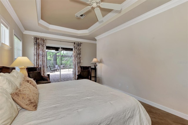 carpeted bedroom with ceiling fan, ornamental molding, a tray ceiling, and access to outside