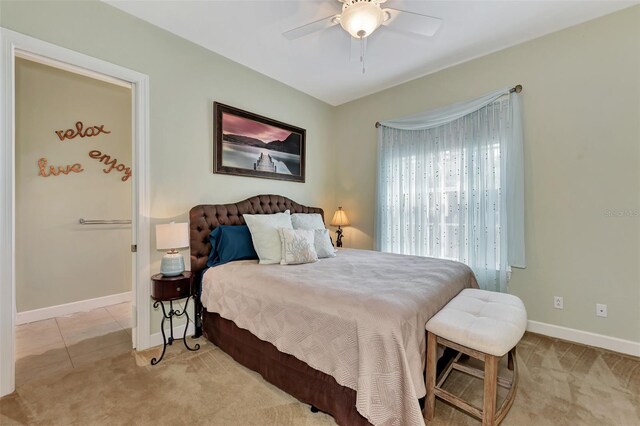 bedroom featuring ceiling fan and light colored carpet