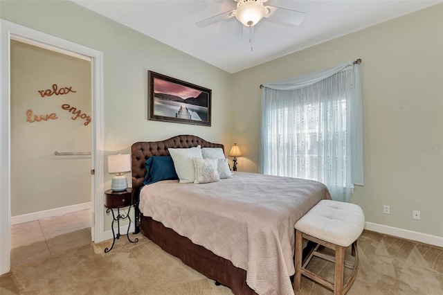 carpeted bedroom with baseboards and a ceiling fan