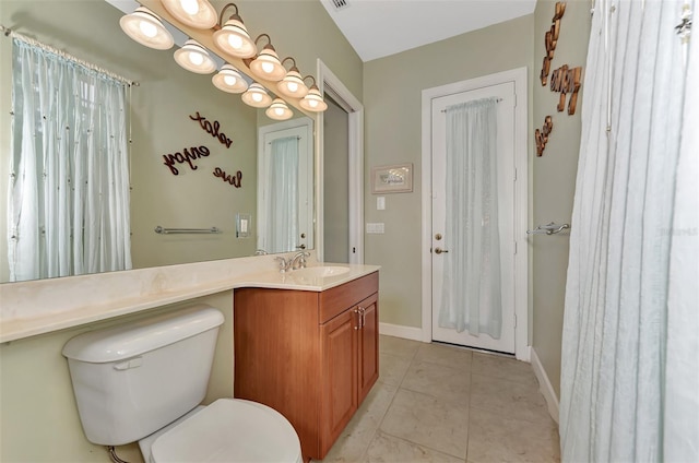 bathroom featuring vanity, toilet, and tile patterned floors