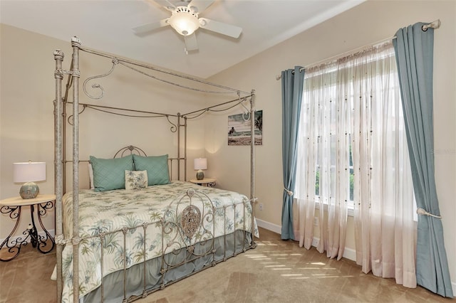 carpeted bedroom with a ceiling fan and baseboards