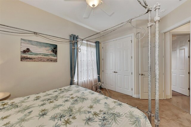 carpeted bedroom featuring ceiling fan and a closet