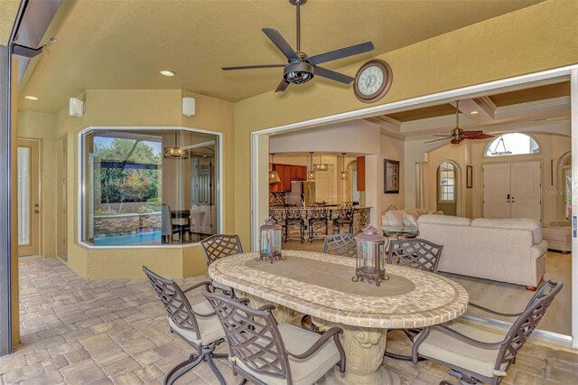 dining area featuring ceiling fan and crown molding