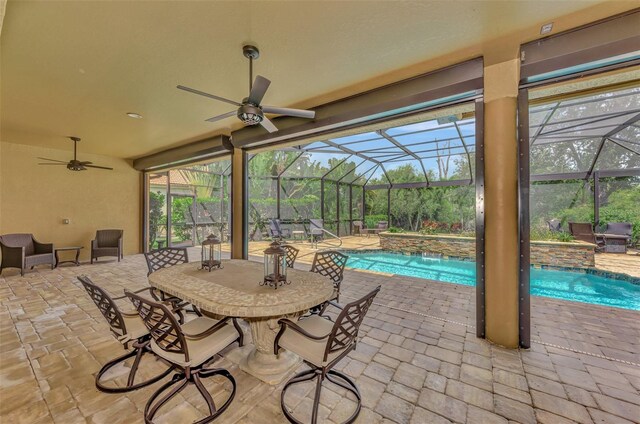 view of patio / terrace featuring a lanai, ceiling fan, and pool water feature