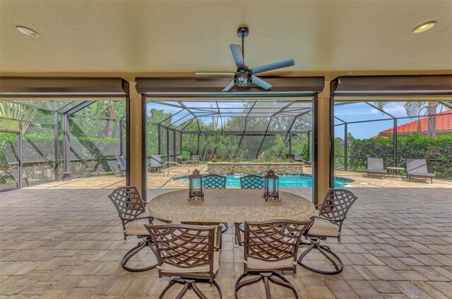 view of patio / terrace with ceiling fan and a lanai