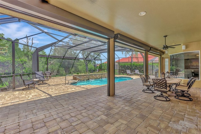 outdoor pool with a patio, a ceiling fan, and a lanai