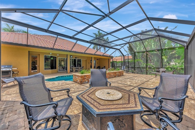 view of patio with grilling area, glass enclosure, and an outdoor pool