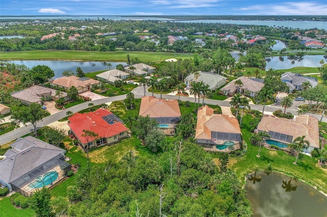 aerial view with a residential view, golf course view, and a water view