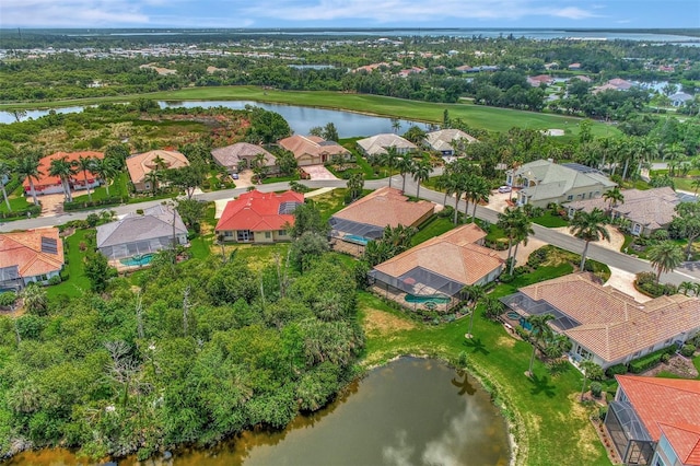 birds eye view of property with golf course view, a water view, and a residential view