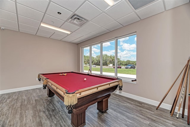 rec room with visible vents, a paneled ceiling, baseboards, and wood finished floors