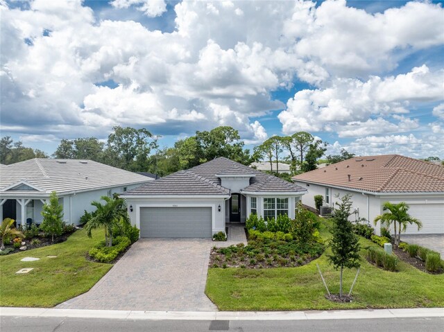 ranch-style house featuring a garage and a front yard