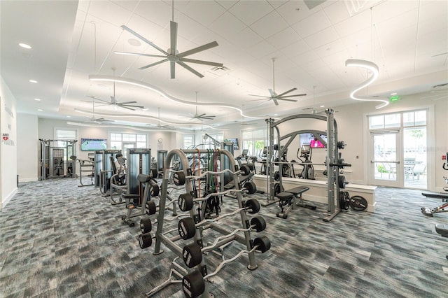 9982 Beachwalk Dr, Englewood, FL 34223 - exercise room with carpet floors, ceiling fan, recessed lighting, baseboards, and a raised ceiling