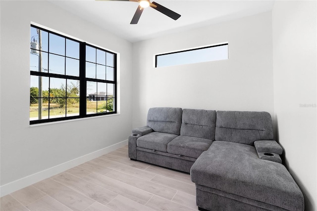 living room featuring ceiling fan and light hardwood / wood-style floors