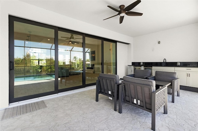 view of patio featuring outdoor lounge area, ceiling fan, and sink