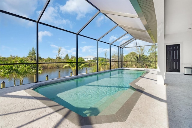 view of pool with a water view, a patio area, and a lanai