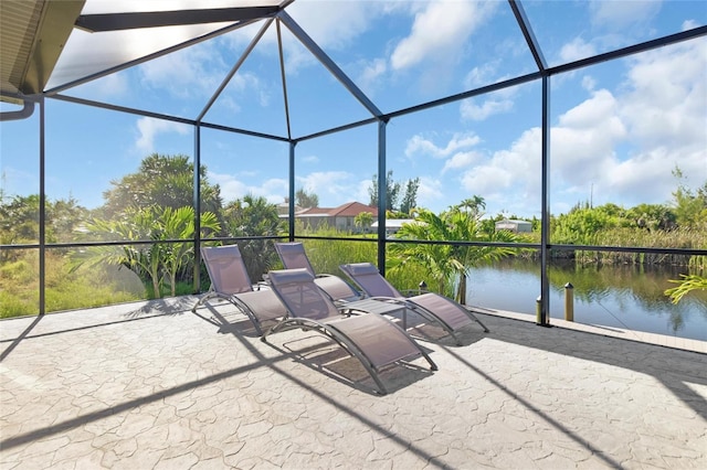 view of patio featuring a water view and a lanai