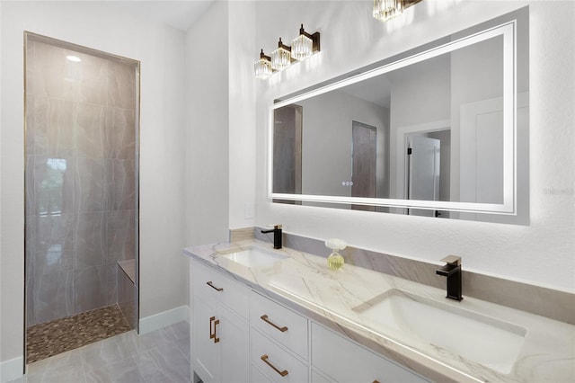 bathroom featuring a tile shower and vanity