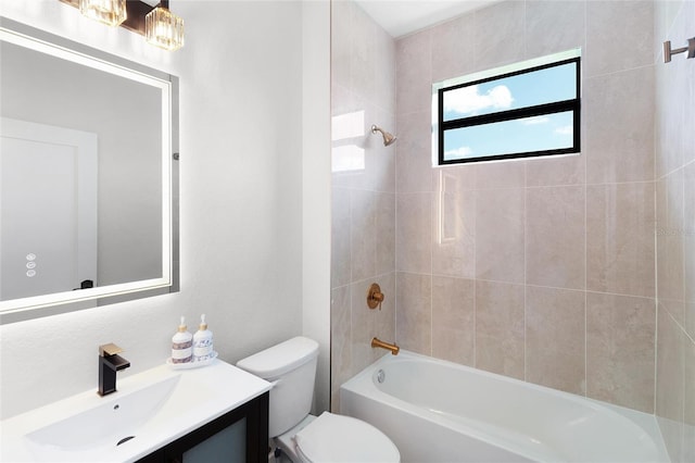 full bathroom with toilet, vanity, and tiled shower / bath