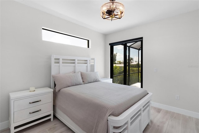 bedroom featuring access to exterior and light hardwood / wood-style floors