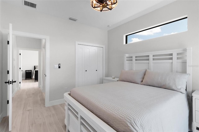 bedroom featuring light hardwood / wood-style floors and a closet