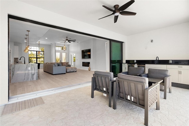 interior space featuring ceiling fan and marble finish floor