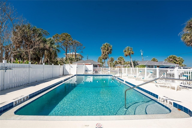 pool featuring a patio area and fence