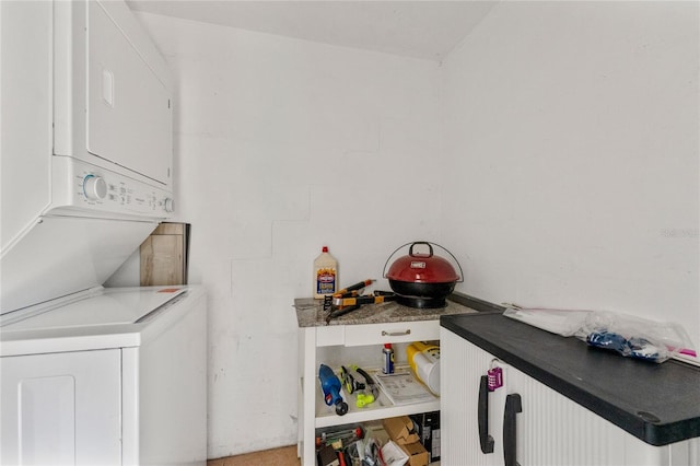 laundry area featuring stacked washer and clothes dryer and laundry area