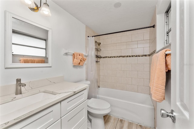 bathroom featuring toilet, vanity, wood finished floors, and shower / bath combo with shower curtain