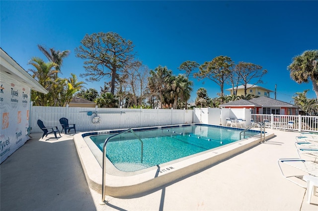 pool featuring a fenced backyard and a patio
