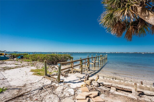 view of dock featuring a view of the beach and a water view