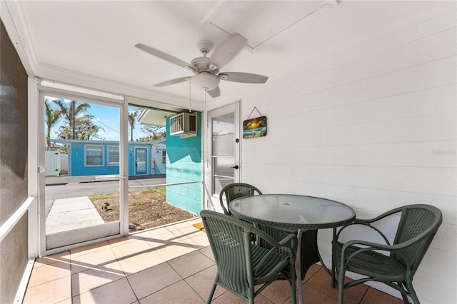 sunroom featuring outdoor dining space, a wall mounted AC, and ceiling fan