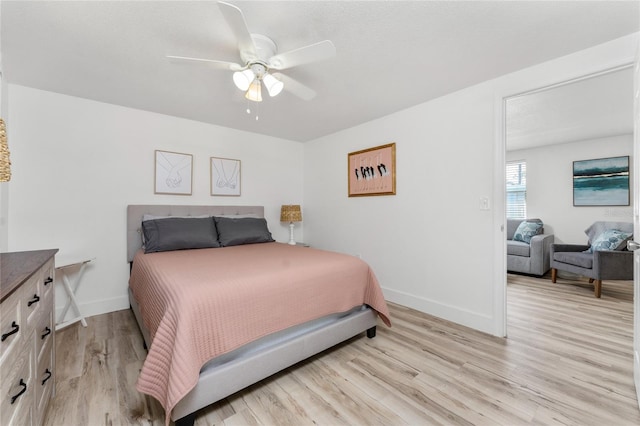 bedroom with light wood-style floors, baseboards, and ceiling fan