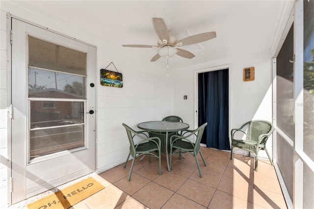 sunroom featuring ceiling fan and outdoor dining area