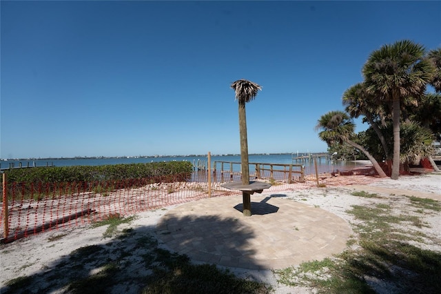 view of yard featuring a water view and a patio