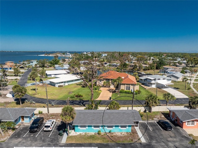 drone / aerial view with a residential view and a water view