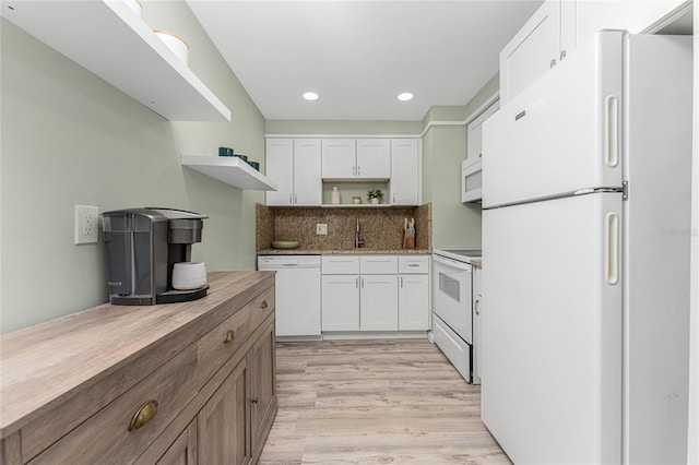 kitchen with white appliances, wood counters, light hardwood / wood-style floors, decorative backsplash, and white cabinets