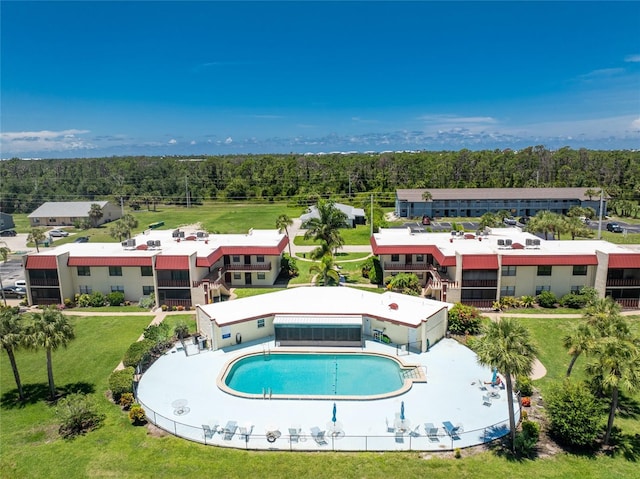 view of pool with a yard