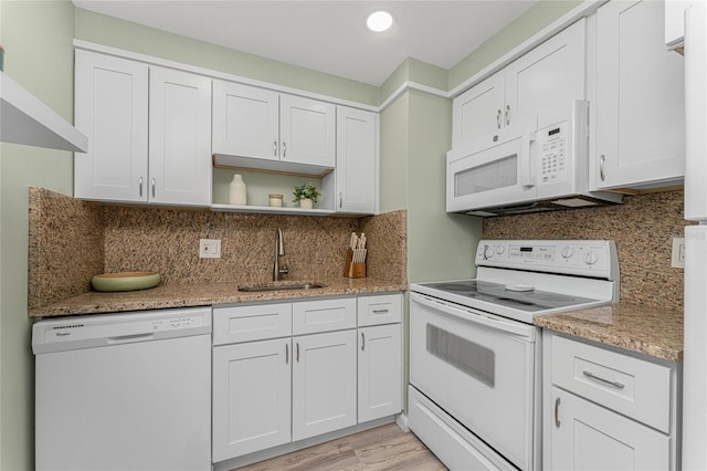 kitchen with white cabinets, white appliances, tasteful backsplash, and sink