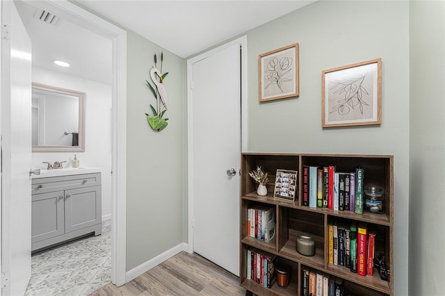 corridor with light hardwood / wood-style flooring