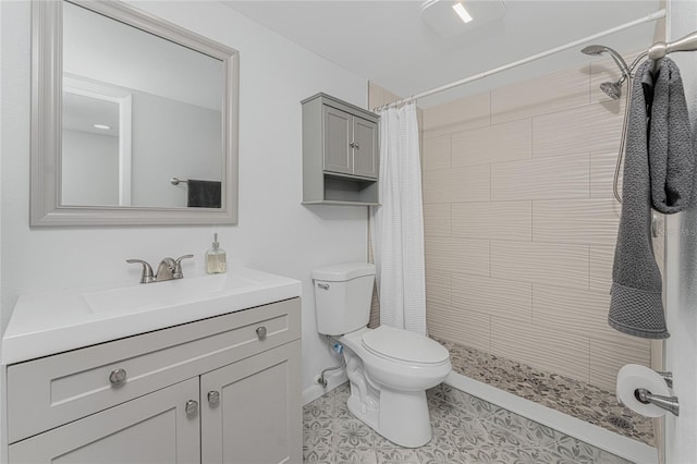 bathroom with walk in shower, toilet, and vanity