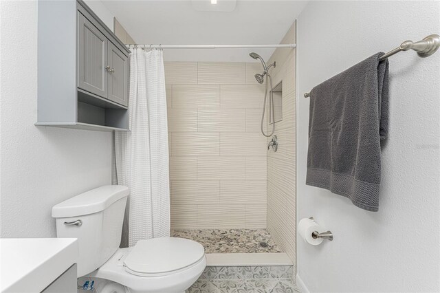 bathroom with tile patterned floors, vanity, toilet, and a shower with shower curtain