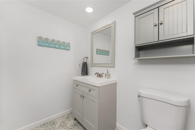 bathroom featuring toilet and vanity