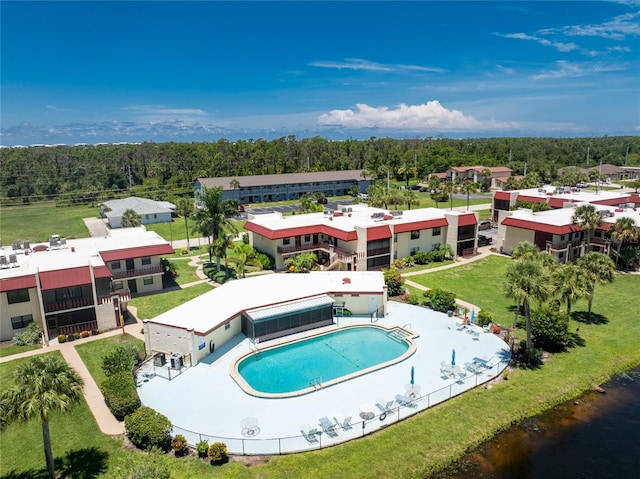 view of swimming pool featuring a patio area and a yard