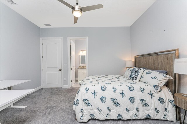 carpeted bedroom featuring connected bathroom and ceiling fan