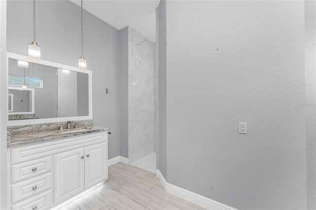 bathroom with walk in shower and vanity