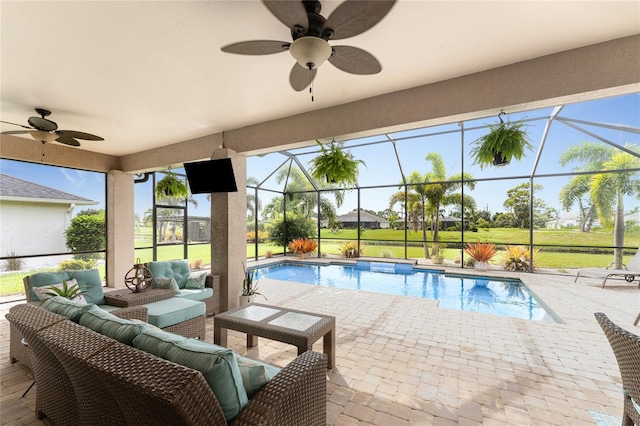 view of swimming pool with a yard, an outdoor living space, a lanai, ceiling fan, and a patio area