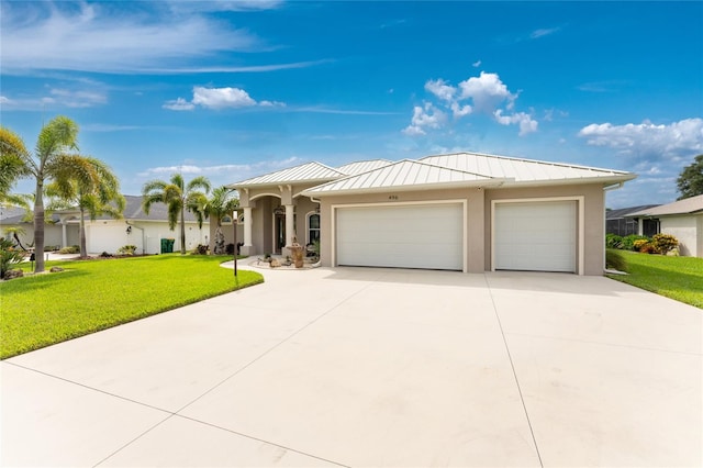 view of front facade with a garage and a front lawn