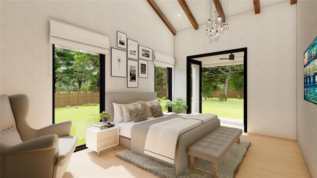 bedroom with access to exterior, vaulted ceiling with beams, and light hardwood / wood-style floors